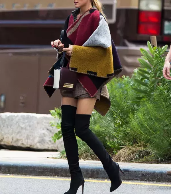 A poncho sweater really complements the thigh-high boots