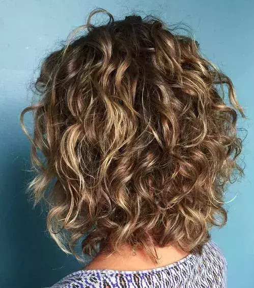 Try an above-the-shoulder hairstyle that adds extra volume and scrunch!